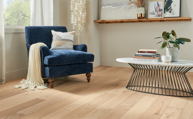 wood flooring in living room with jewel toned armchair